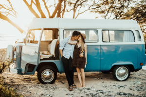 Andrew and Lindsey Roman in front of a blue vw bus